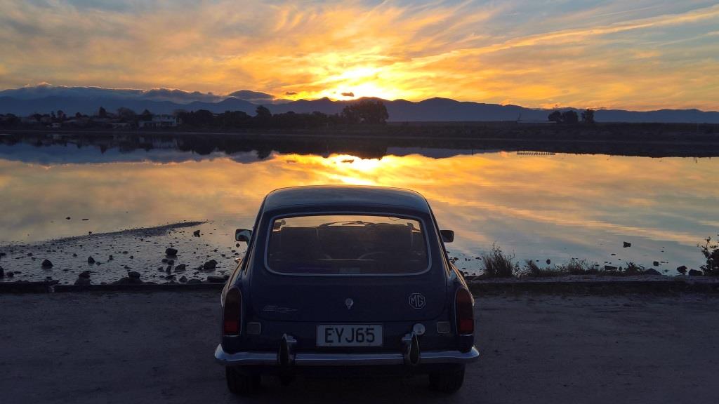 1972 MG BGT rear shot taken into sun setting over water